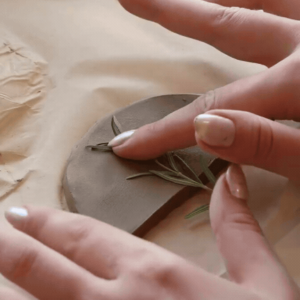 Air dry clay being shaped by hand, slowly